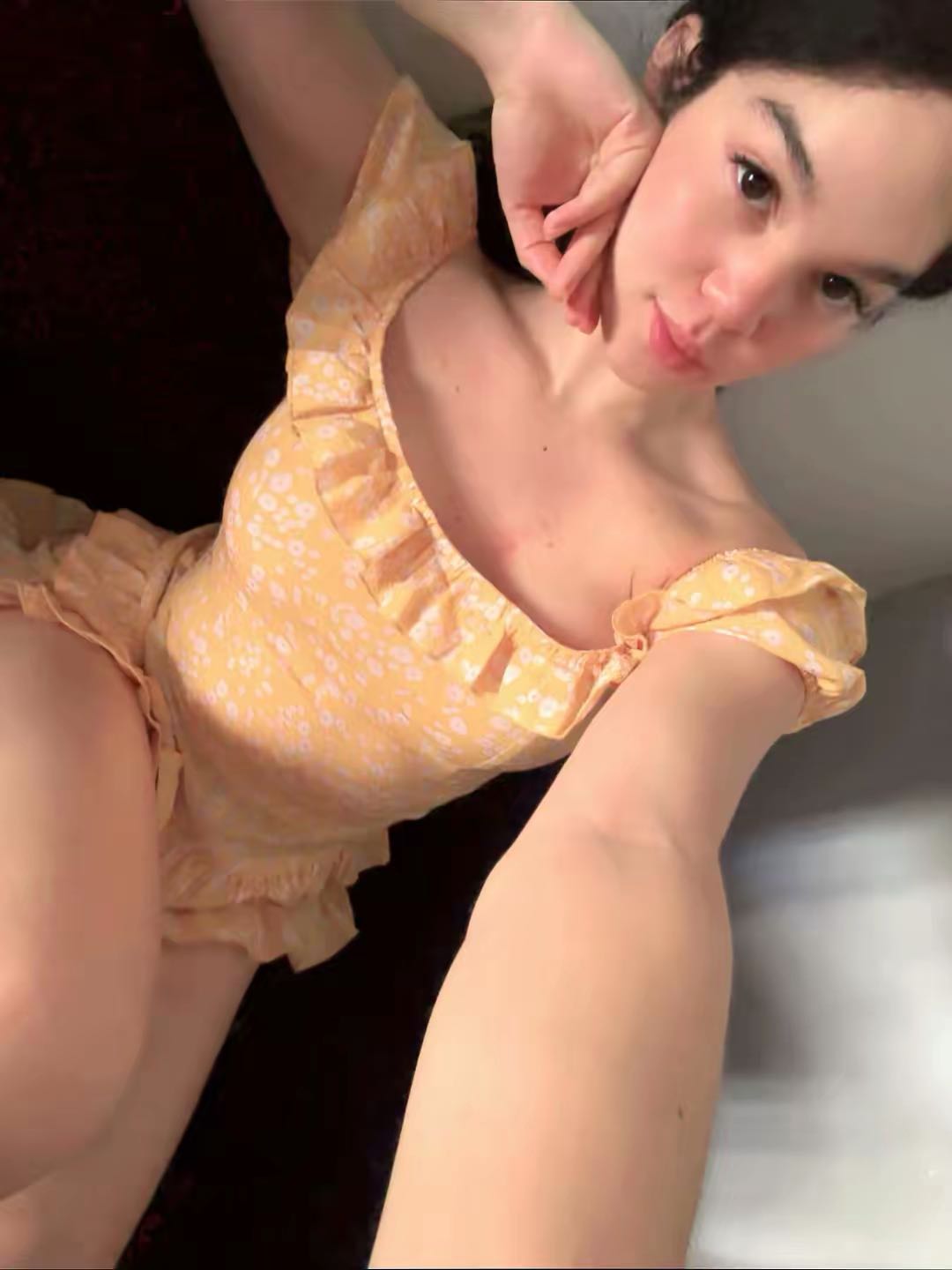 woman in a yellow dress glancing into the camera on ChatSpace TV
