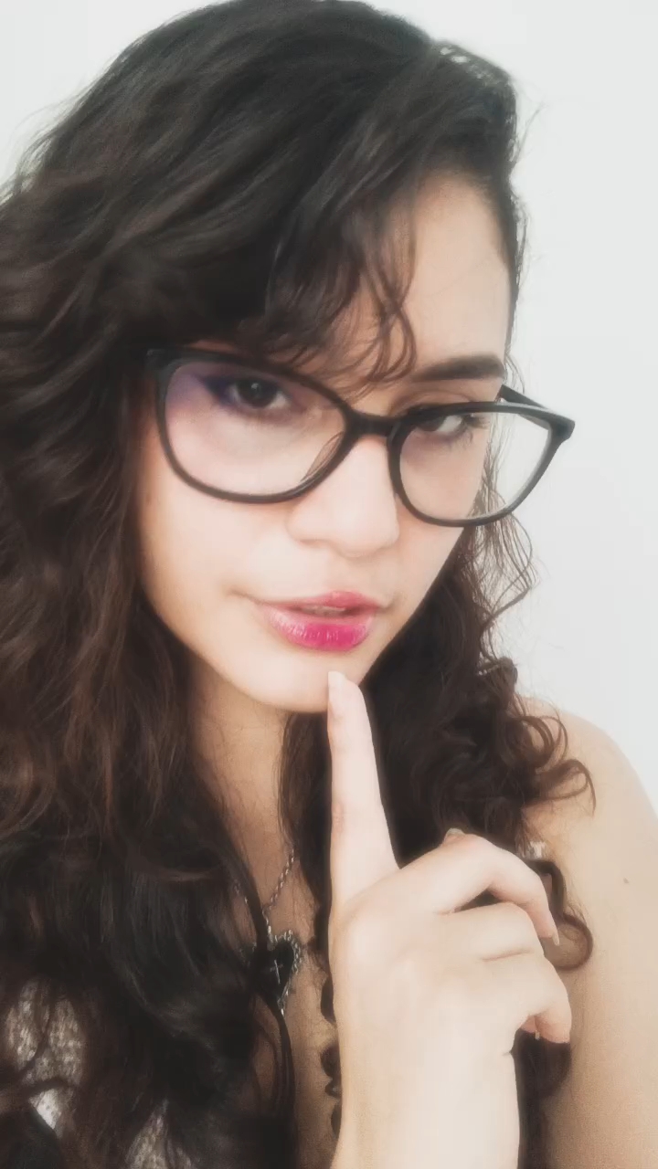 woman with glasses smiling at the camera, online on ChatSpace TV