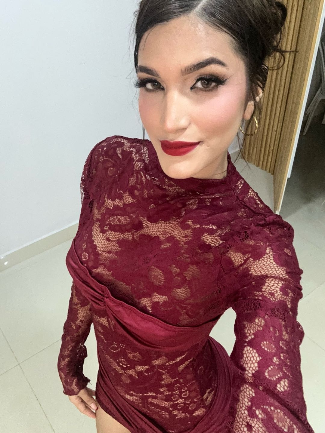 woman in a burgundy lace dress looking into the camera on ChatSpace TV